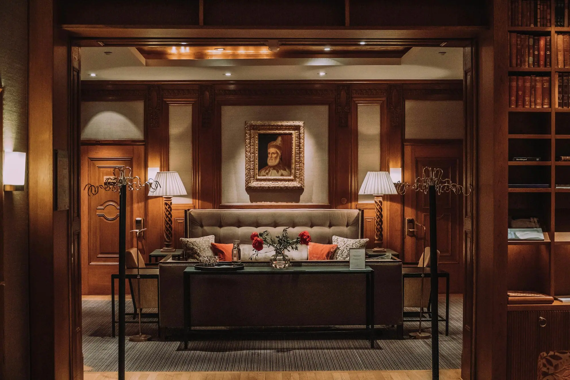 Wood-panelled living room with warm lighting and classic furniture