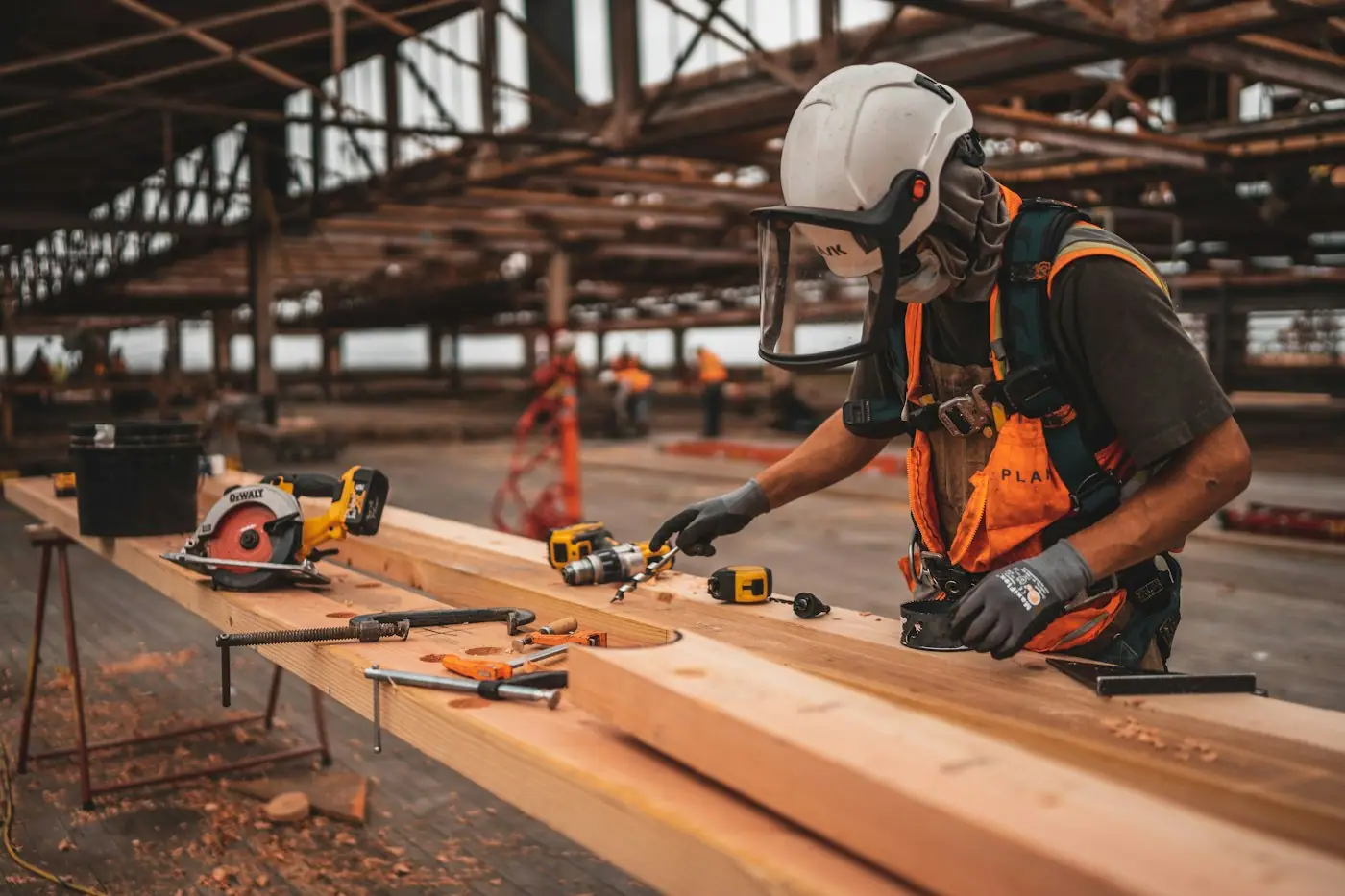 Site carpenter cutting timber in a workshop